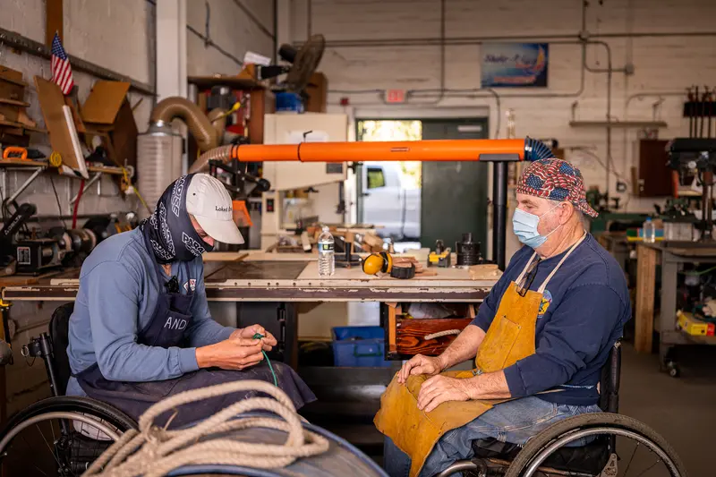 Two people working together in a community workshop