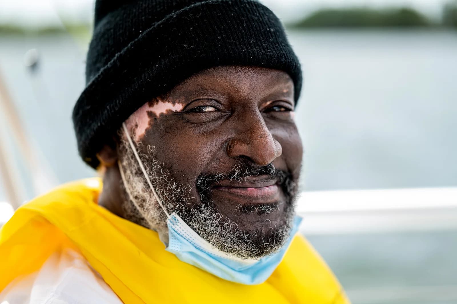 Community member smiling warmly on a boat